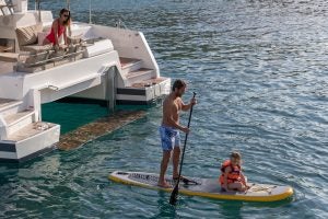 Family on swim platform of Fountaine Pajot Astrea 42 catamaran