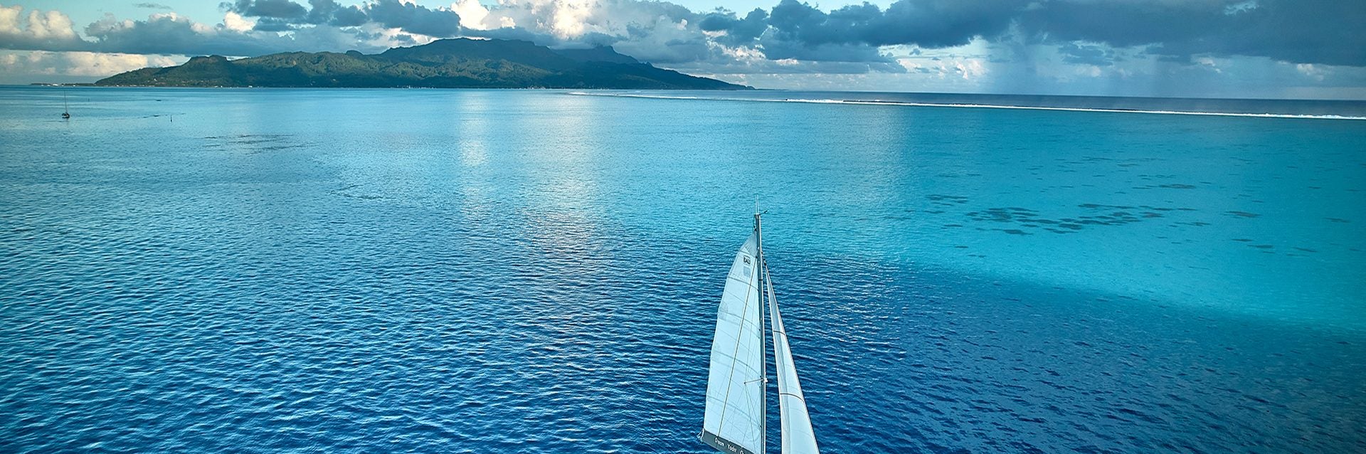 Woman on side deck of yacht in partnership ownership program enjoying view