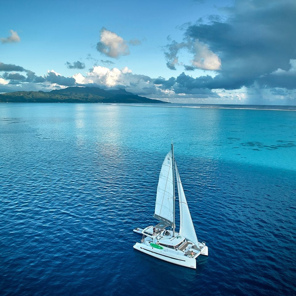 Woman on side deck of yacht in partnership ownership program enjoying view