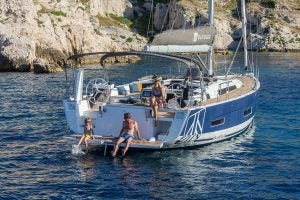 People enjoying swim platform on a Dufour 530 monohull