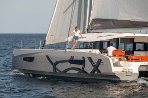 Couple on deck enjoying Excess 14 yacht