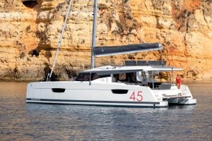 Fountaine Pajot Elba 45 at anchor with woman on deck