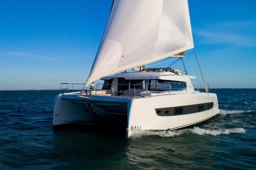 Bali 4.4 catamaran sailing with blue sky backdrop