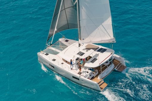 Aerial view Lagoon 42 catamaran sailing in blue water