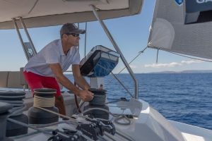 Man at the helm of the Fountaine Pajot Alegria 67 catamaran