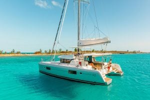 Lagoon 42 sailing catamaran anchored near sandy shore