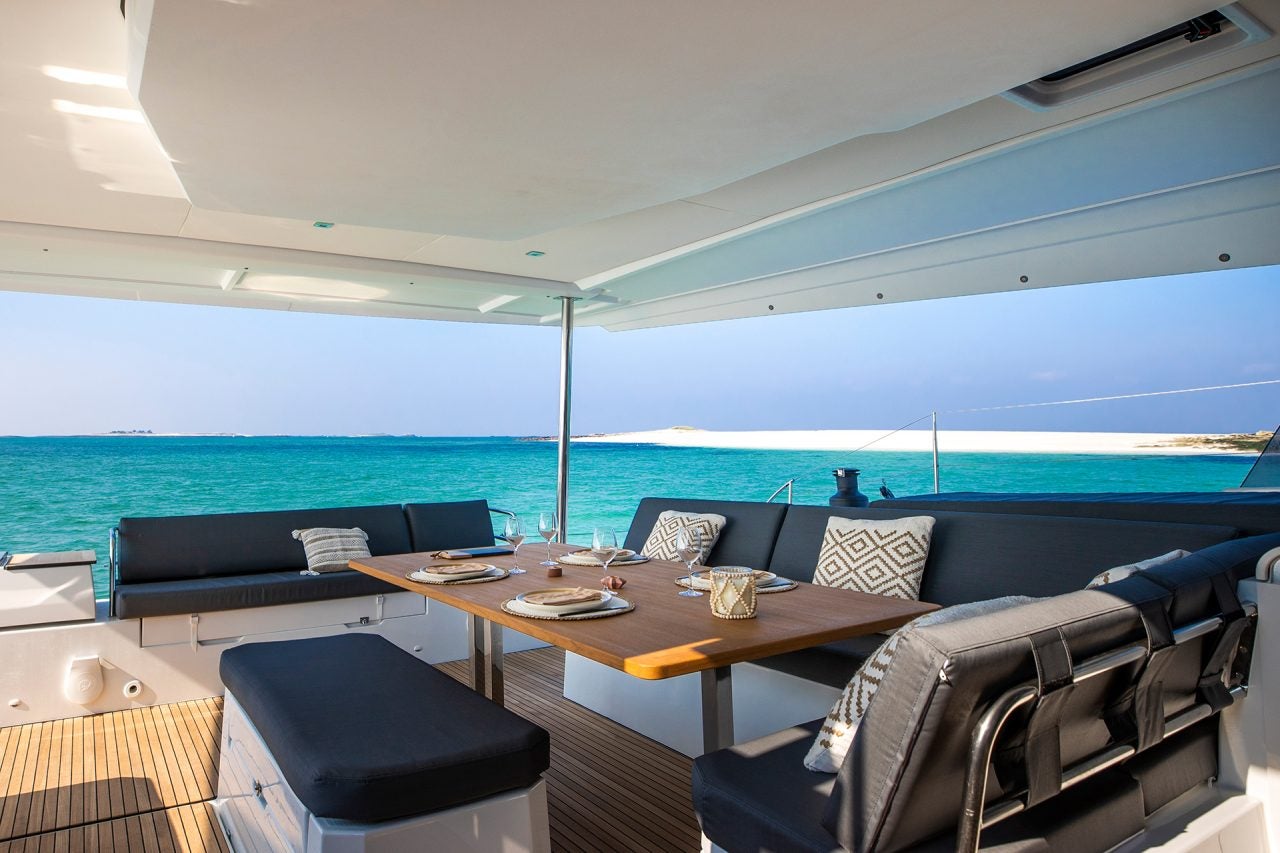 Luxury cushioned cockpit dining area on the Fountaine Pajot Aura 51 catamaran