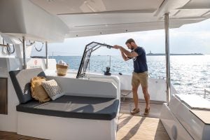 Man entering cabin from deck of the Aura 51 catamaran