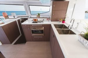 Large dark wood kitchen with wrap around windows aboard the Bali 4.8