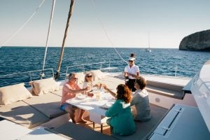 People at the outdoor foredeck table for dinner on the Bali 5.4