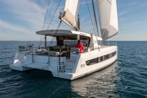 Bali Catsmart cruising with sails up and man at helm