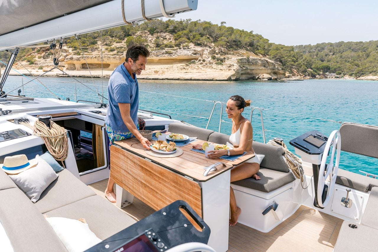 Couple enjoying cockpit dining area on Dufour 41 monohull