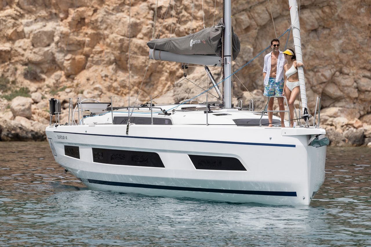 Dufour 41 sailing boat with couple standing on the bow