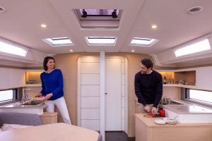 Couple cooking in the kitchen of a Dufour 44 sailing monohull