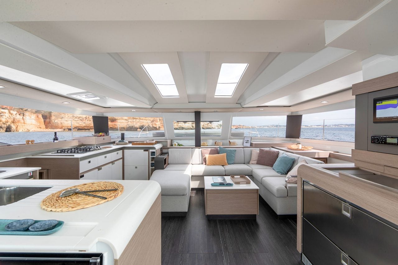 Wide view of spacious saloon of the Fountaine Pajot Electric Elba 45 sailing yacht