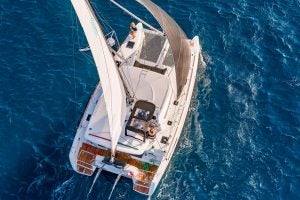 Aerial view of the Lagoon 40 catamaran sailing in blue water