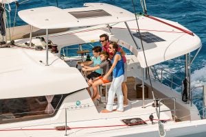 Family a the helm of the Lagoon 42 catamaran sailboat