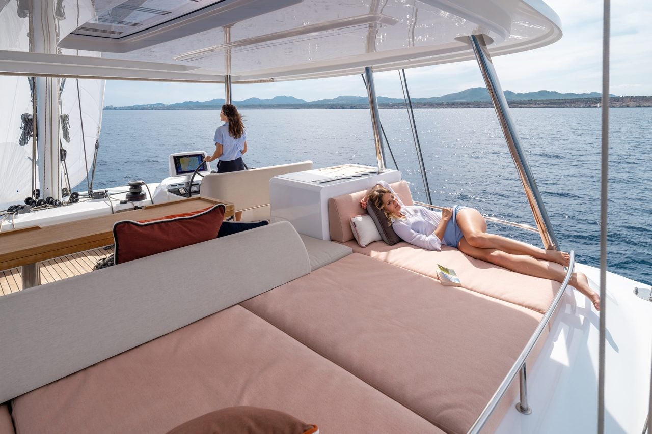 Woman at the helm of the Lagoon 55 yacht