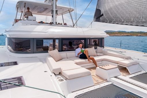 Lagoon luxury sailing catamaran with man on front deck