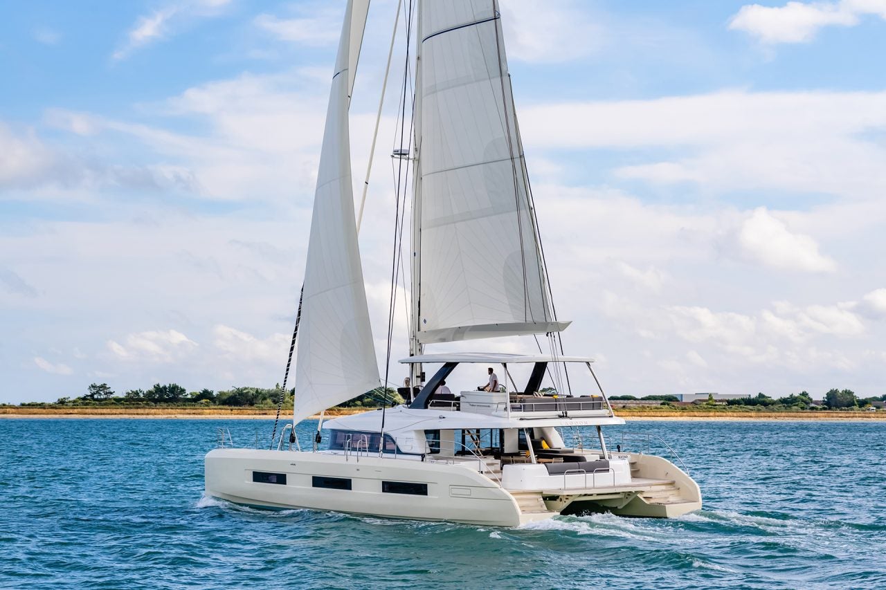 Lagoon 65 luxury yacht at sail near shore