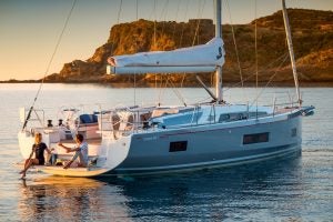 Oceanis 46.1 sailboat with couple on swim platform