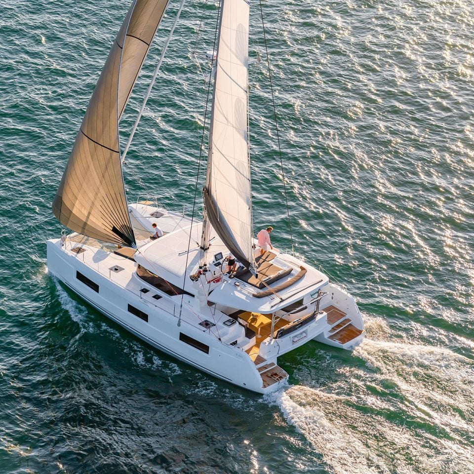 Dream Yacht sailing catamaran with sails up aerial view