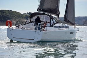 Sun Odyssey 380 sailboat at sail with man at helm