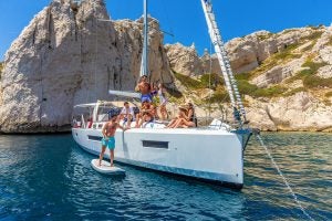 Large group of people on foredeck of the Jeanneau Sun Loft 47 monohull