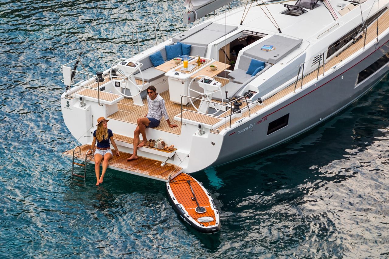 Beneteau Oceanis 46.1 sailboat with couple enjoying swim platform